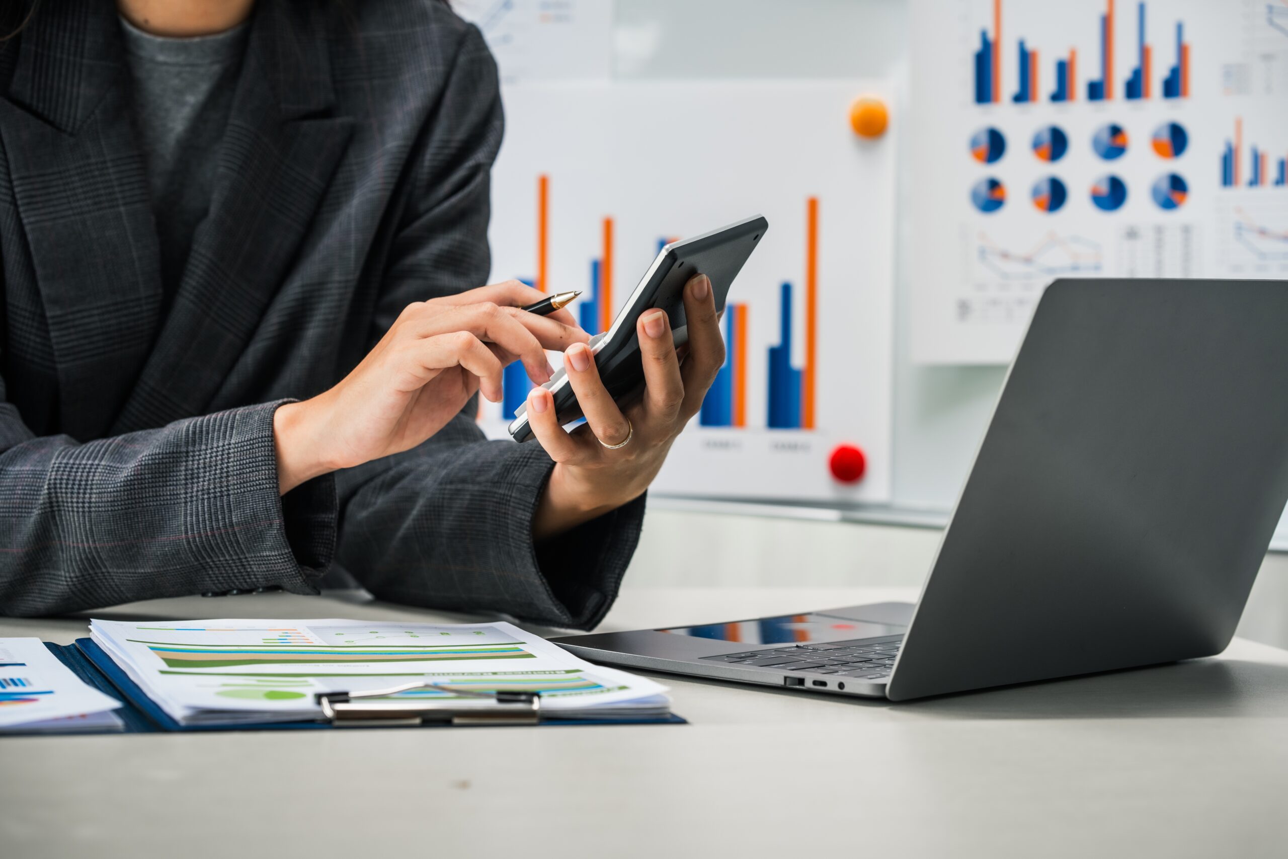 A,Businesswoman,Works,Diligently,At,Her,Desk,,Reviewing,Financial,Documents